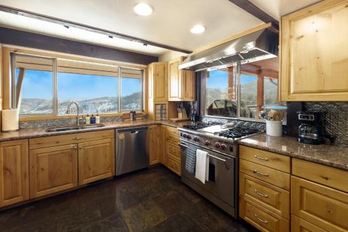 a kitchen with wooden cabinets and a stove top oven at Cozy Rustic Escape in Park City