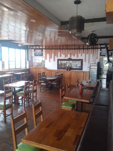 a dining room with tables and chairs in a restaurant at Casa Nativa Iquitos in Iquitos