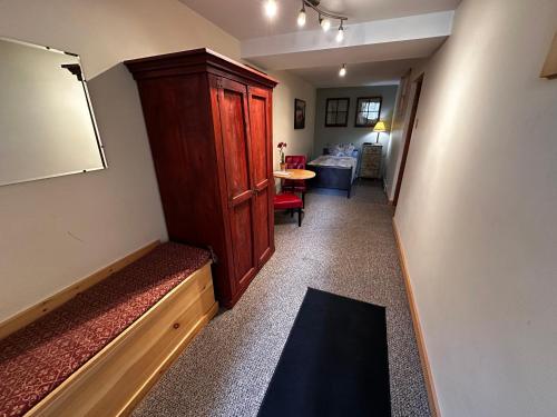 a hallway with a large wooden cabinet in a room at Chewuch Inn & Cabins in Winthrop