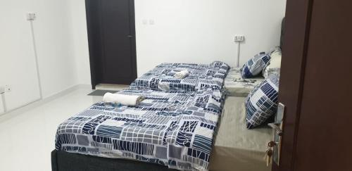 a group of three beds in a room at International Abu-Dhabi Hostel Villa in Abu Dhabi