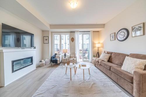 a living room with a couch and a fireplace at Entire home in Oakville, Canada in Oakville