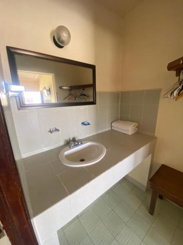 a bathroom with a sink and a mirror at Hotel Posada Santa Fe Sabinas in Sabinas