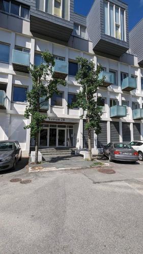 a large building with cars parked in front of it at Stylish urban apartment in Stavanger
