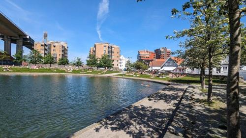 a body of water in a city with buildings at Stylish urban apartment in Stavanger
