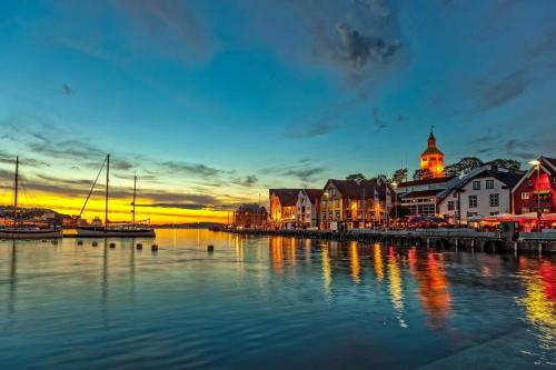 a town with a marina with boats in the water at Stylish urban apartment in Stavanger