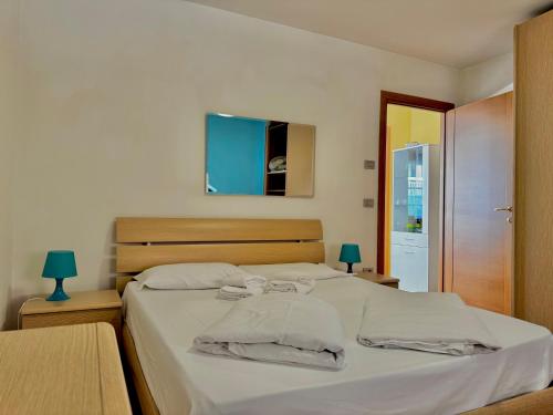 a bedroom with a large bed with white sheets at 1Dest - Sweet Spot in Riva del Garda