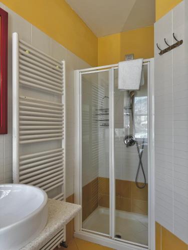 a bathroom with a glass shower and a sink at 1Dest - Sweet Spot in Riva del Garda