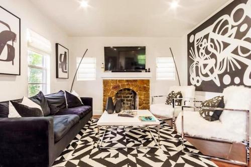 a living room with a couch and a fireplace at 4BD 2BA - Black&White ArtBNB - Antique Row WPB in West Palm Beach