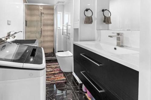 a white bathroom with a sink and a toilet at Regent Residential House in Whangarei