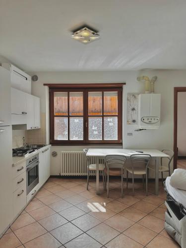 a kitchen with a table and chairs in a kitchen at 1Dest - Sweet Spot in Riva del Garda