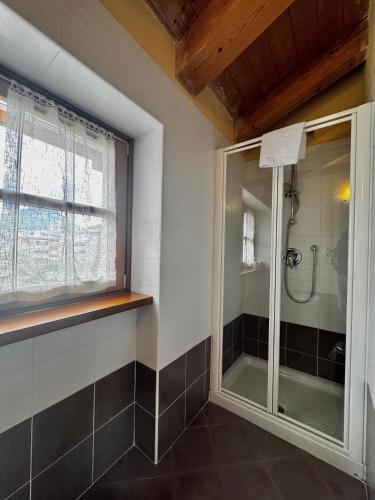 a bathroom with a shower with a glass door at 1Dest - Sweet Spot in Riva del Garda