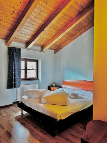 a bedroom with two beds and a wooden ceiling at 1Dest - Sweet Spot in Riva del Garda