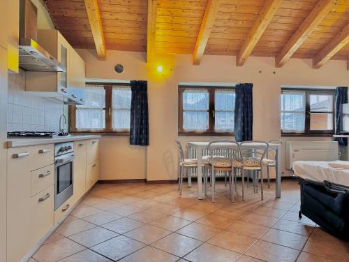 a kitchen with a table and chairs in it at 1Dest - Sweet Spot in Riva del Garda