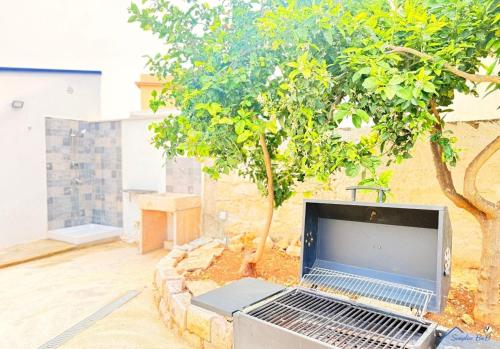 a laptop computer sitting on the ground next to a tree at Sicilia bedda in Custonaci