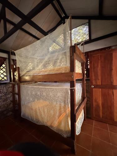 two bunk beds in a room with a door at Finca Tatin Hotel in Lámpara
