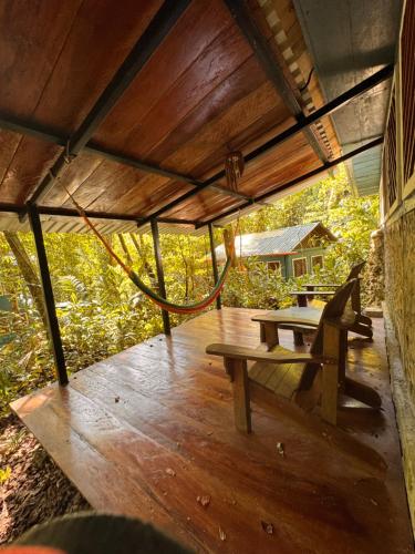 a picnic table and a bench on a deck at Finca Tatin Hotel in Lámpara
