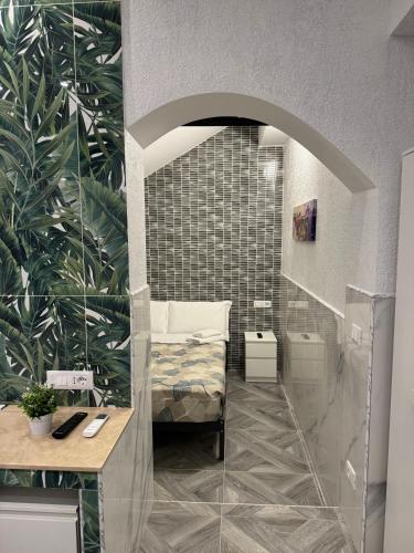 a room with a bed and a mirror at LUXOR ECO ROMA CASA E APPARTAMENTO PER VACANZE IN CENTRO Piazza Bologna, Colosseo, Piazza di Spagna, Vaticano, San Pietro, Sapienza, Fontana di Trevi, Piazza Navona, Trastevere, Tiburtina, Termini, Aeroporto in Rome