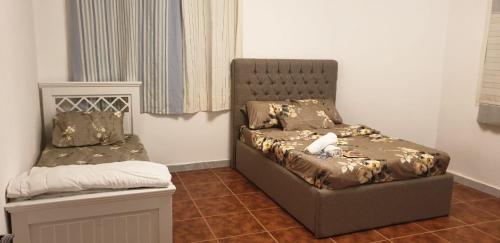 a bedroom with a bed with a stuffed animal on it at International Abu Dhabi Hostel in Abu Dhabi