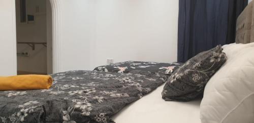 a bed with a blanket and pillows on it at International Abu Dhabi Hostel in Abu Dhabi