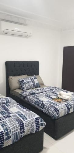 two beds sitting next to each other in a room at International Abu Dhabi Hostel in Abu Dhabi