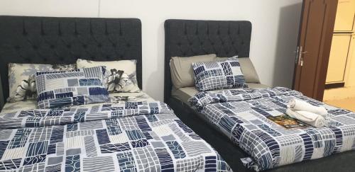 two beds sitting next to each other in a room at International Abu Dhabi Hostel in Abu Dhabi