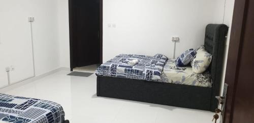 a bedroom with a bed with a comforter and pillows at International Abu Dhabi Hostel in Abu Dhabi