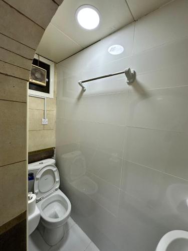 a bathroom with a toilet and a sink at International Abu Dhabi Hostel in Abu Dhabi