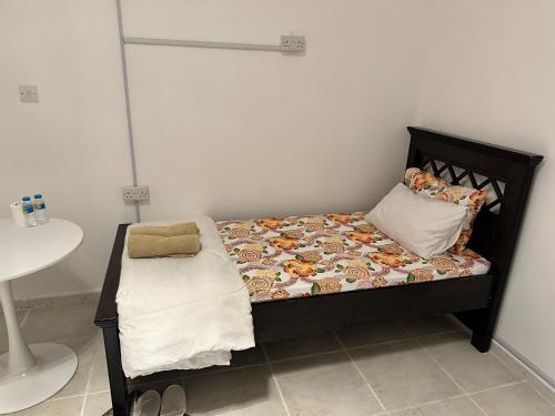 a small bedroom with a bed and a sink at International Abu Dhabi Hostel in Abu Dhabi