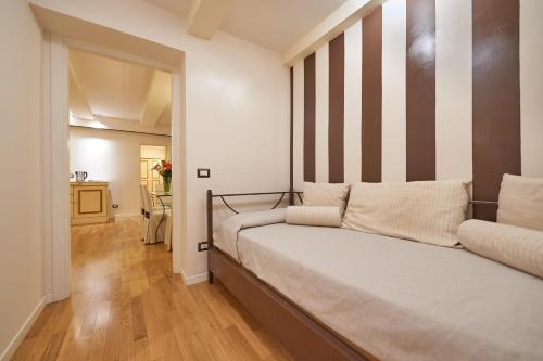 a bedroom with a bed with a striped headboard at B&B Le Stanze del Duomo in Florence