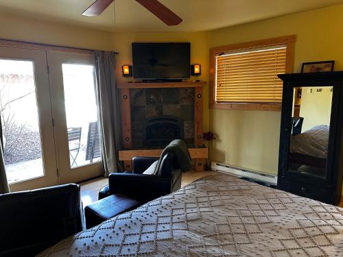 a bedroom with a large bed and a fireplace at Chewuch Inn & Cabins in Winthrop