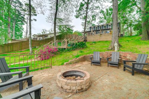 a fire pit with chairs and a house in the background at Waterfront House on Toledo Bend with Private Dock! in Alliance