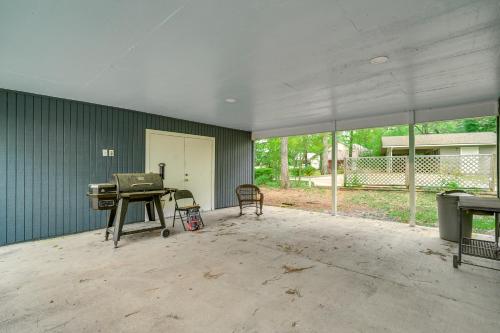 an empty room with a grill and a table in it at Waterfront House on Toledo Bend with Private Dock! in Alliance