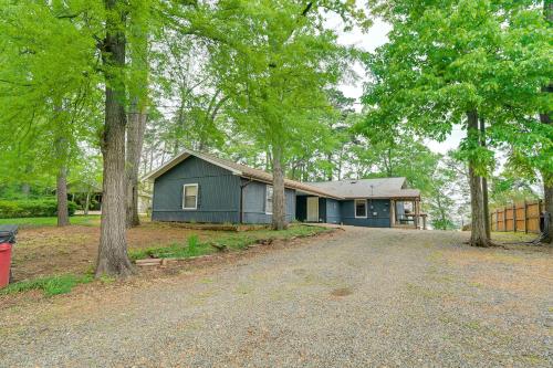 a blue house with trees in front of it at Waterfront House on Toledo Bend with Private Dock! in Alliance
