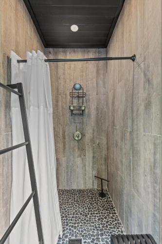 a shower with a shower curtain in a bathroom at WiFi & Adventure - The Overlook Luxury in Rogers