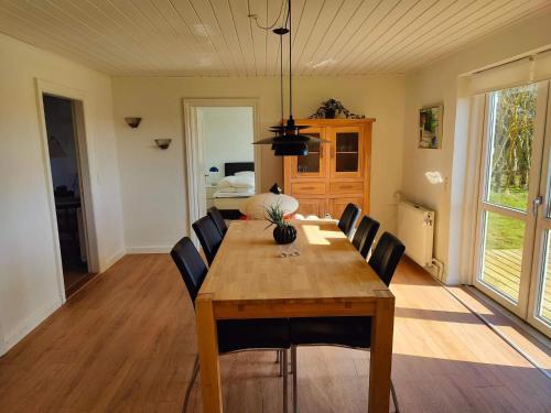 a dining room with a wooden table and chairs at 4 star holiday home in Løkken in Løgsted