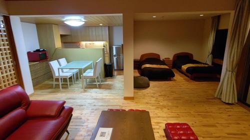 a living room with a couch and a table at condominium SAKURA B5 in Hakone