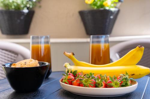 a plate of strawberries and bananas on a table at Sunset Loft Crete in Thérissos