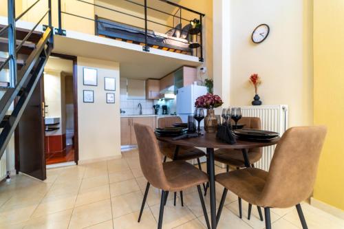 a kitchen and dining room with a table and chairs at Sunset Loft Crete in Thérissos