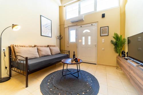 a living room with a couch and a table at Sunset Loft Crete in Thérissos