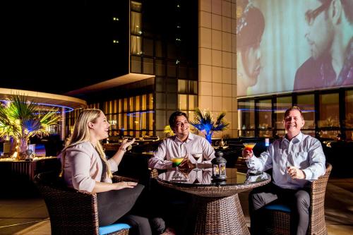 a group of people sitting at a table in a restaurant at Novotel Abu Dhabi Gate in Abu Dhabi