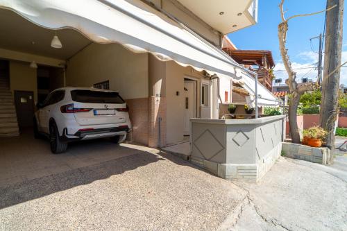 a white car parked outside of a house at Sunset Loft Crete in Thérissos