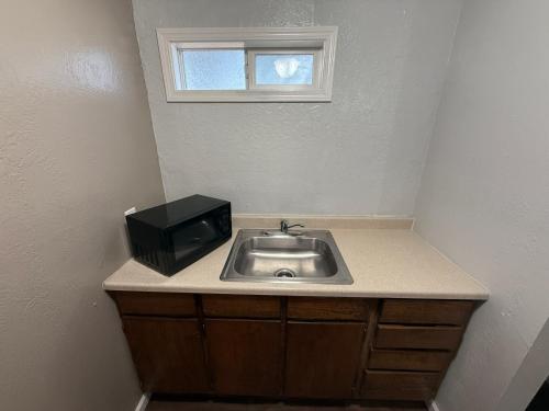 a bathroom with a sink and a tv on top of it at Budget Inn Bend in Bend