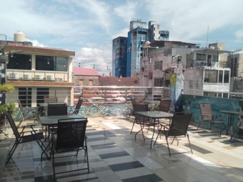 a patio with tables and chairs on a roof at Casa Nativa Iquitos in Iquitos
