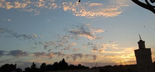a view of a cloudy sky at sunset at Hotel Bab Boujloud in Fès