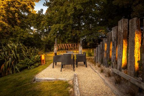 a table and chairs in front of a fence at Ngaa Manu Guest House Tamahere Hamilton in Rukuhia
