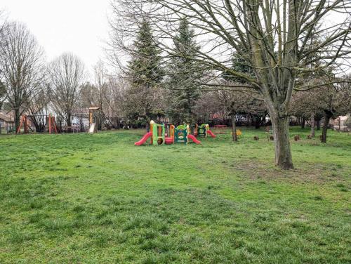 a park with playground equipment in the grass at Holiday home in Kötcse - Südtransdanubien 53934 in Kötcse