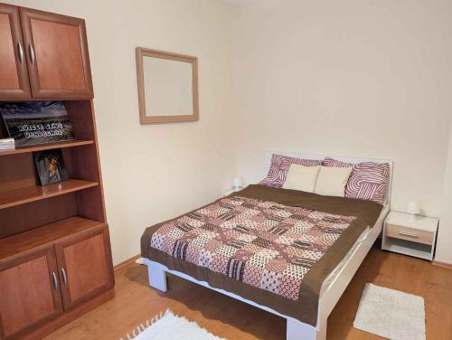 a small bedroom with a bed and a cabinet at Holiday home in Kötcse - Südtransdanubien 53934 in Kötcse