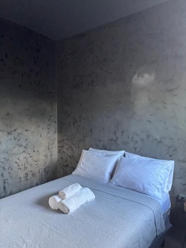 a bedroom with a bed with two towels on it at Pousada Água Salgada in Ilha de Boipeba