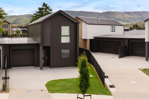 a house with a black garage at Stirling Woods Retreat in Cromwell