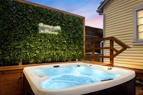 a bath tub sitting in front of a green hedge at Downtown Historic 2Bdrm, Walk to Riverwalk, Alamo; Beautifully Renovated! in San Antonio